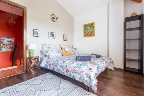 a bedroom with a bed with a colorful bedspread at La villa du Moulin Castin in Castin
