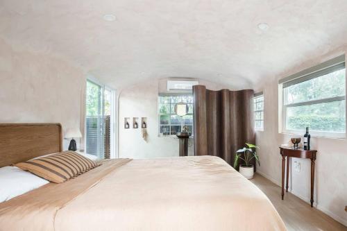 a bedroom with a large bed and two windows at Terra Villeta - at lumicollection in Miami