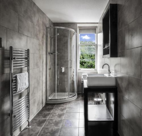 a bathroom with a sink, toilet and tub at Invergarry Hotel in Invergarry