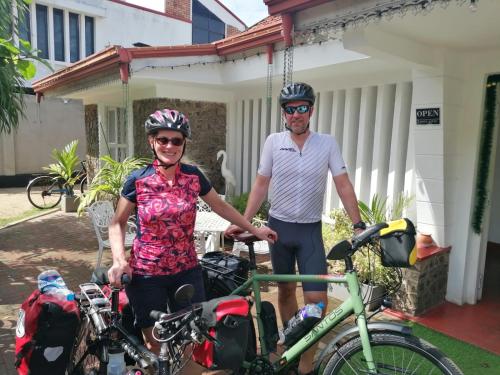 a man and a woman standing next to their bikes at Villa Fernando Resort in Chilaw