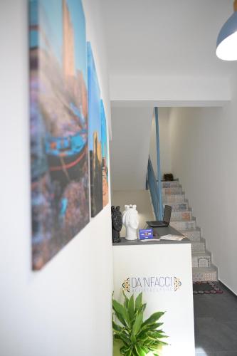a table with a picture on the wall and a plant at Da 'Nfacci Affittacamere in Carini