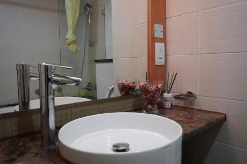 a bathroom with a white sink and a mirror at Peace House-private room with bathroom for 2 guest in Dubai