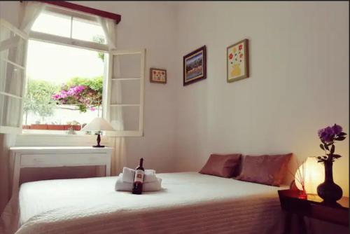 a bedroom with a white bed and a window at Vila São Gonçalo in Funchal