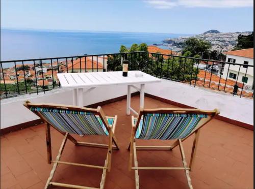 a white table and two chairs on a balcony at Vila São Gonçalo in Funchal