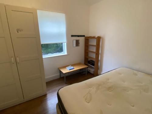 a bedroom with a bed and a window and a table at The Meadows in Marshfield