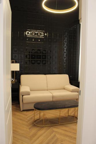 a living room with a couch and a table at Nero Luxury Suites in Cagliari