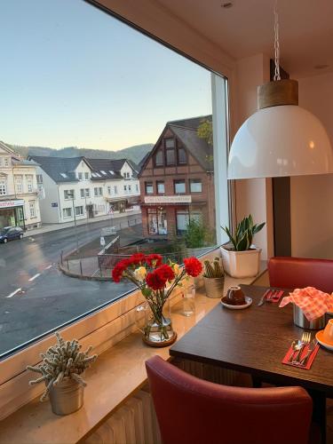 a dining room with a large window with a table at Hotel Wittgensteiner Hof in Bad Laasphe