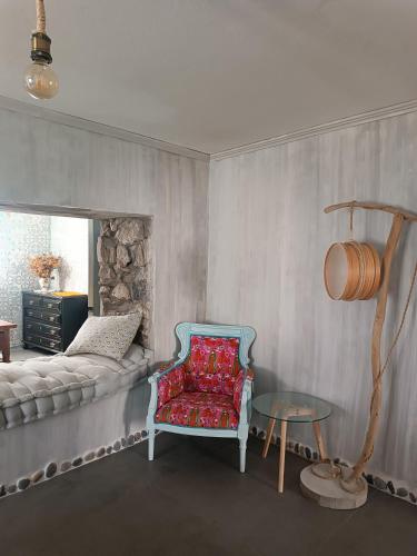 a living room with a couch and a chair at Avó da Rosa 1 in Ribeira Quente