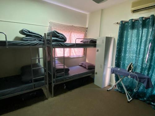 a room with two bunk beds and a window at Dubai Zeus Hostel in Dubai