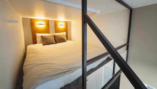 a bed in a small room with a window at City Apartments in Tallinn