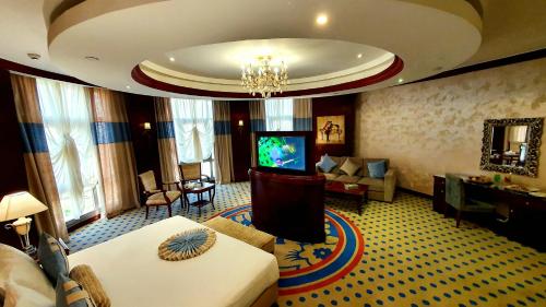 a hotel room with a living room with a television at Jewel Sport City and Aqua Park in Cairo