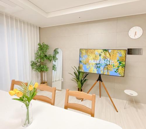 a living room with a flat screen tv on a tripod at Ari Home - Free parking, 15mins to Cheonan Station, 20mins Sejong Emerson, 25mins to Woojeong Hills in Cheonan