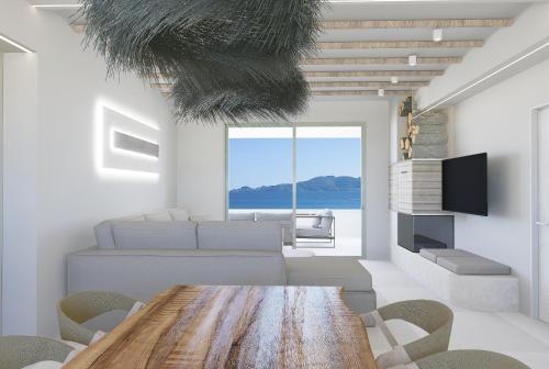 a living room with a wooden table and chairs at Haraki Village in Haraki