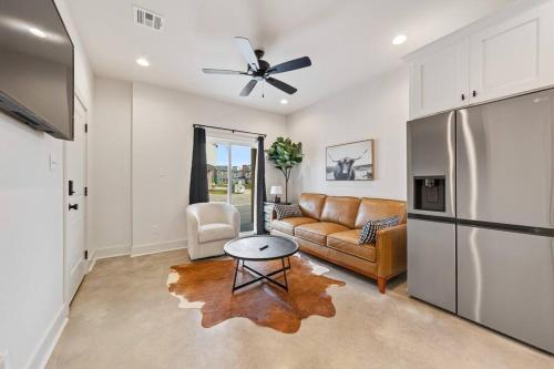 a living room with a couch and a refrigerator at Creole House/KING bed/Relax in Cajun Comfort! in Lafayette