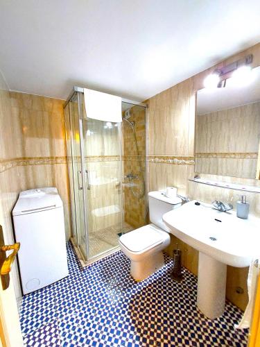 a bathroom with a toilet and a sink and a shower at Conteros Centro Apartment in Seville