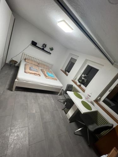 Schlafzimmer mit einem Bett, einem Tisch und Stühlen in der Unterkunft LittleHome in Hornberg