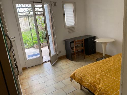 a bedroom with a bed and a table and a door at Lille in Lille