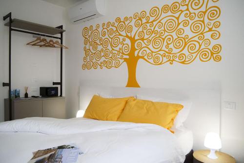a bedroom with a tree mural on the wall at Casadamare in Lido di Jesolo