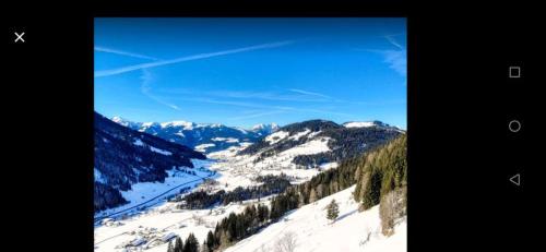 a view of a snowy mountain with trees and mountains at Haus Joelblick und Haus Oberadelsber in Oberau