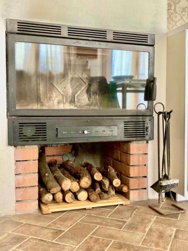 a fire place with logs inside of it at Poderino di Santa Lucia in Villa Nagliati