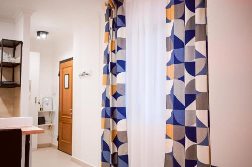 a room with a blue and white curtain at Splendido Monolocale A Roma in Casale Smeraldi