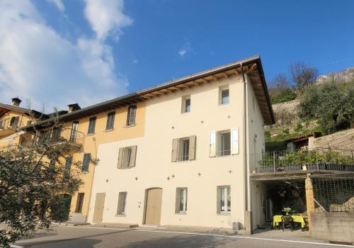a large white building with a balcony at Angelo&Marì Mountain Lake Iseo Hospitality in Marone