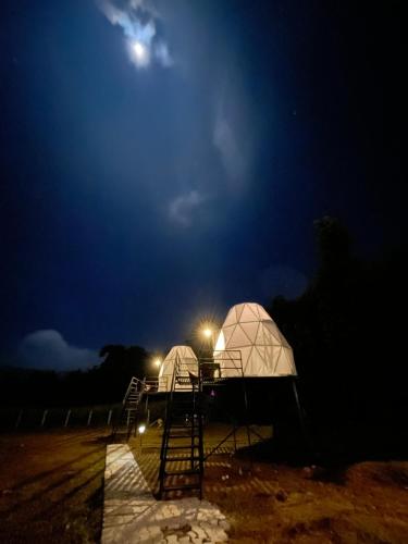 two domes in a field at night with the moon at Croft Yelagiri - glamping stay in Yelagiri