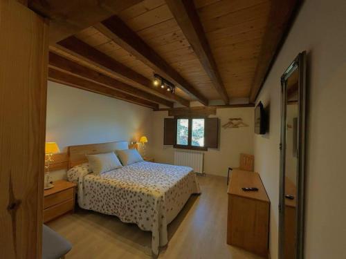 a bedroom with a bed and a wooden ceiling at Hotel Rural El Rincón de Marta in Yanguas