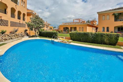 a large blue swimming pool in front of a building at Luxury Banus Puerto Golf in Marbella
