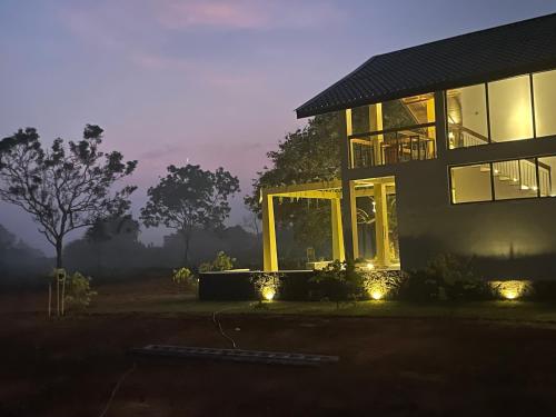 a house with lights in front of it at night at The Villa Lakeshore in Anuradhapura