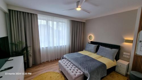 ein Schlafzimmer mit einem Bett und einem großen Fenster in der Unterkunft Nico's stylish Apartment in Satu Mare