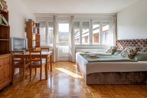 a bedroom with a bed and a table and a dining room at ROOF TERRACE access CASTLE dst. PARLIAMENT 1stop in Budapest