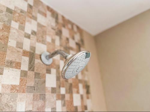 a shower with a shower head in a bathroom at Best View Malindi Guest House in Mwembe Maepe