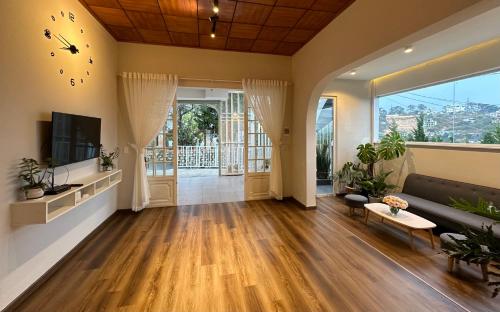 a living room with a couch and a tv at La Mer House Đà Lạt in Ấp Ða Lợi