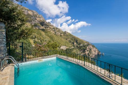 a swimming pool with a view of the ocean at Seacliff Heaven - De Vivo Realty Positano in Arola
