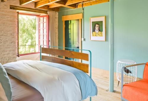 a bedroom with a bed and a window at Le Moulin du Mottay in Évran