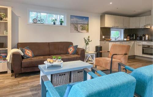 a living room with a couch and a table at Pet Friendly stacaravan In Hardenberg With Kitchen in Hardenberg