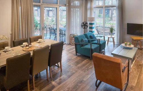 a dining room and living room with a table and chairs at Pet Friendly stacaravan In Hardenberg With Kitchen in Hardenberg