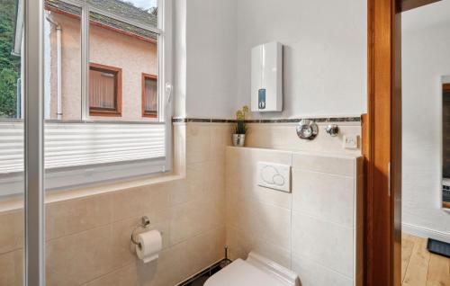 a bathroom with a toilet and a window at 1 Bedroom Cozy Apartment In Pommern in Pommern