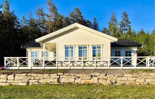 a white house with a stone wall at Amazing Home In Lunde With Wifi in Lunde
