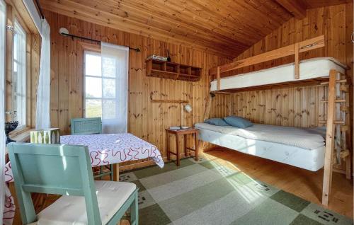 a room with two bunk beds and a table at Beautiful Home In Kil With Wifi in Rolfsbol