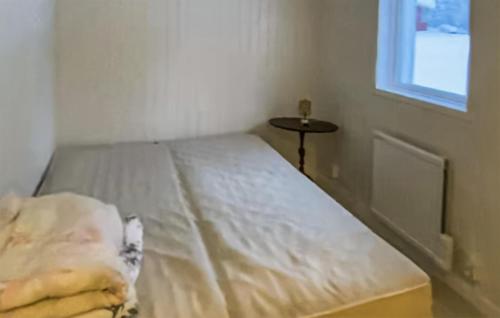 a white bed in a room with a window at Amazing Home In Hunge With 4 Bedrooms in Bräcke