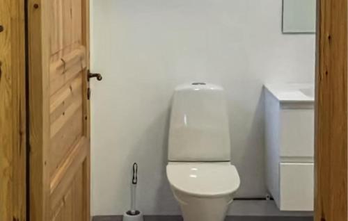 a bathroom with a white toilet in a room at Nice Home In Hunge With House Sea View in Bräcke