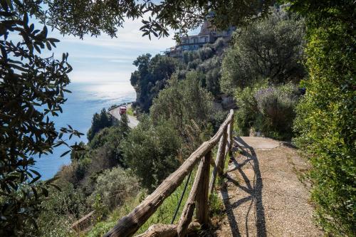 a view of the amalfi coast with a house on a mountain at Seacliff Heaven - De Vivo Realty Positano in Arola