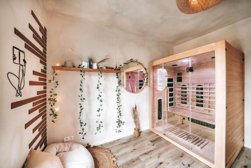 a room with a glass door and a mirror at GetAway Penthouse: Spa & Cinema in Echternacherbrück