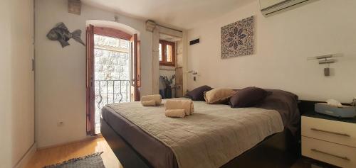 a bedroom with a large bed in front of a door at Fidelissima Palace in Korčula