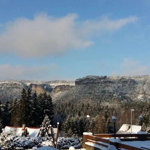 a view of the mountains with snow on the ground at Penzion u Marešů in Hřensko