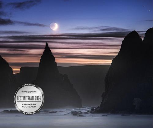 a picture of the moon in the sky with mountains at Caithness View Luxury Farm Lodges and BBQ Huts in Wick