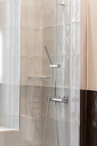 a shower with a glass door in a bathroom at Major House - Luxury Apartments in Rome by Hostand in Rome