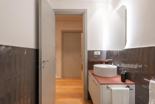 a bathroom with a sink and a mirror at Major House - Luxury Apartments in Rome by Hostand in Rome